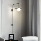 Swing arm wall lamp with frosted glass shade in a living room
