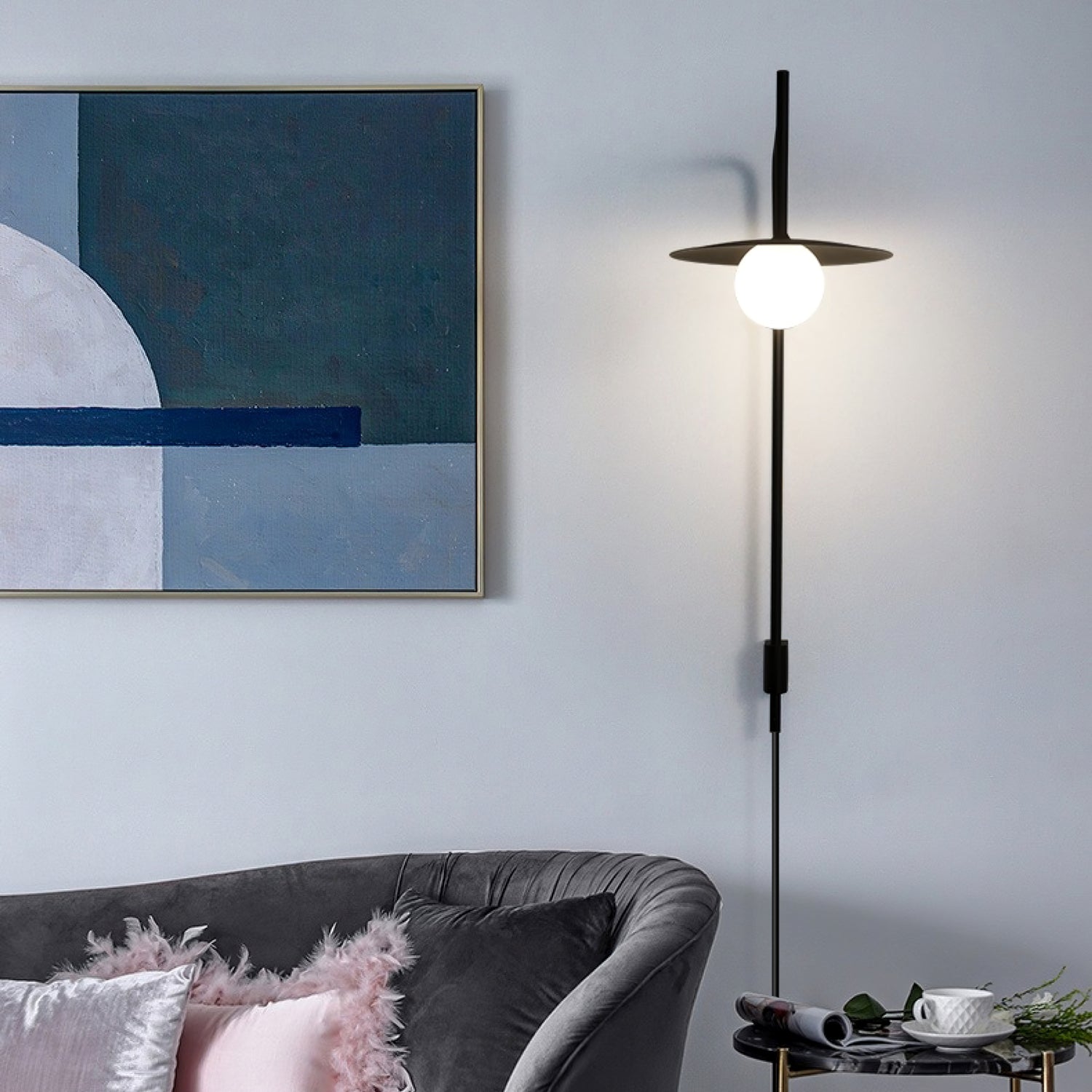 Black swing arm wall lamp with frosted glass shade glowing