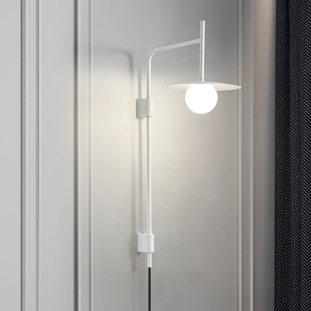 Swing arm wall lamp angled over a chair with soft glow