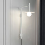 Swing arm wall lamp angled over a chair with soft glow