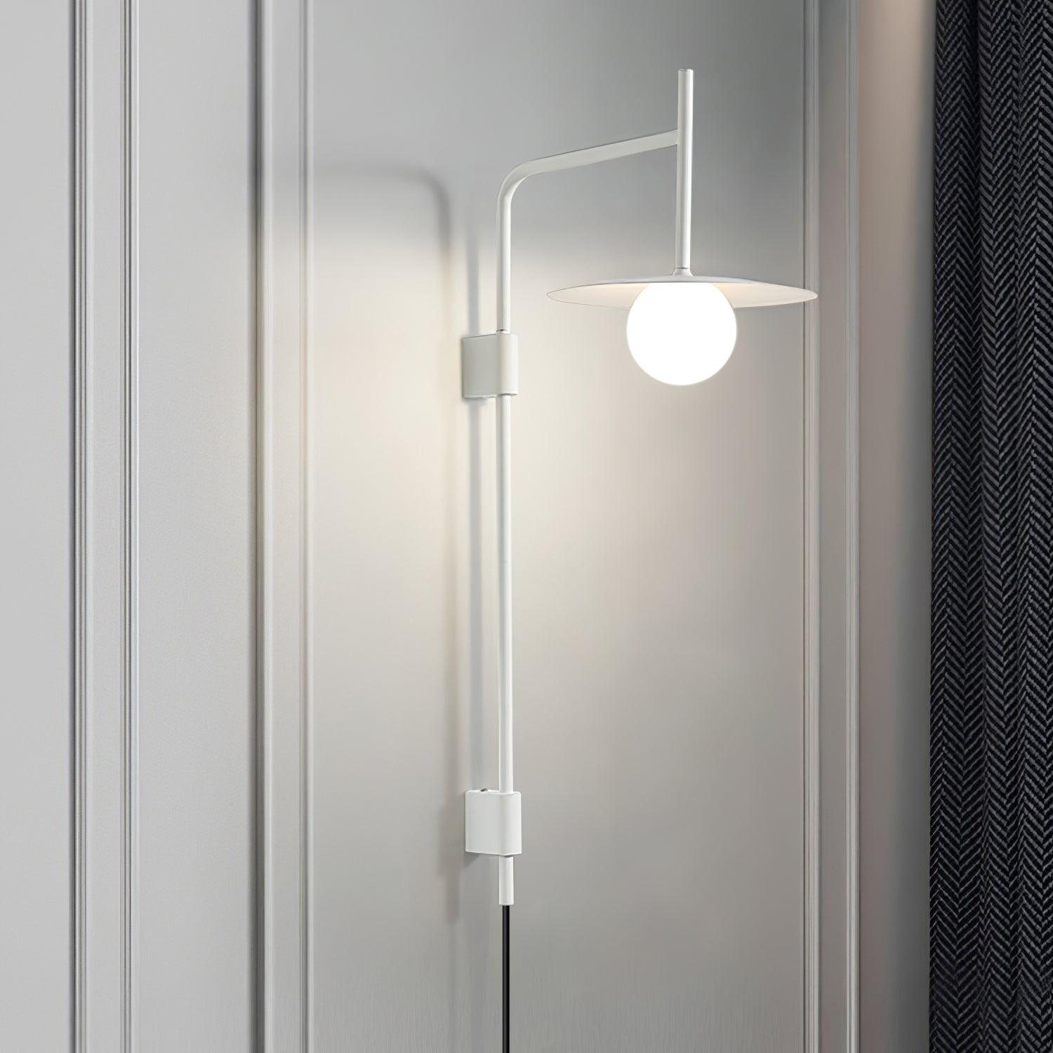 Swing arm wall lamp angled over a chair with soft glow