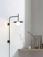 Swing arm wall lamp with frosted glass shade switched on