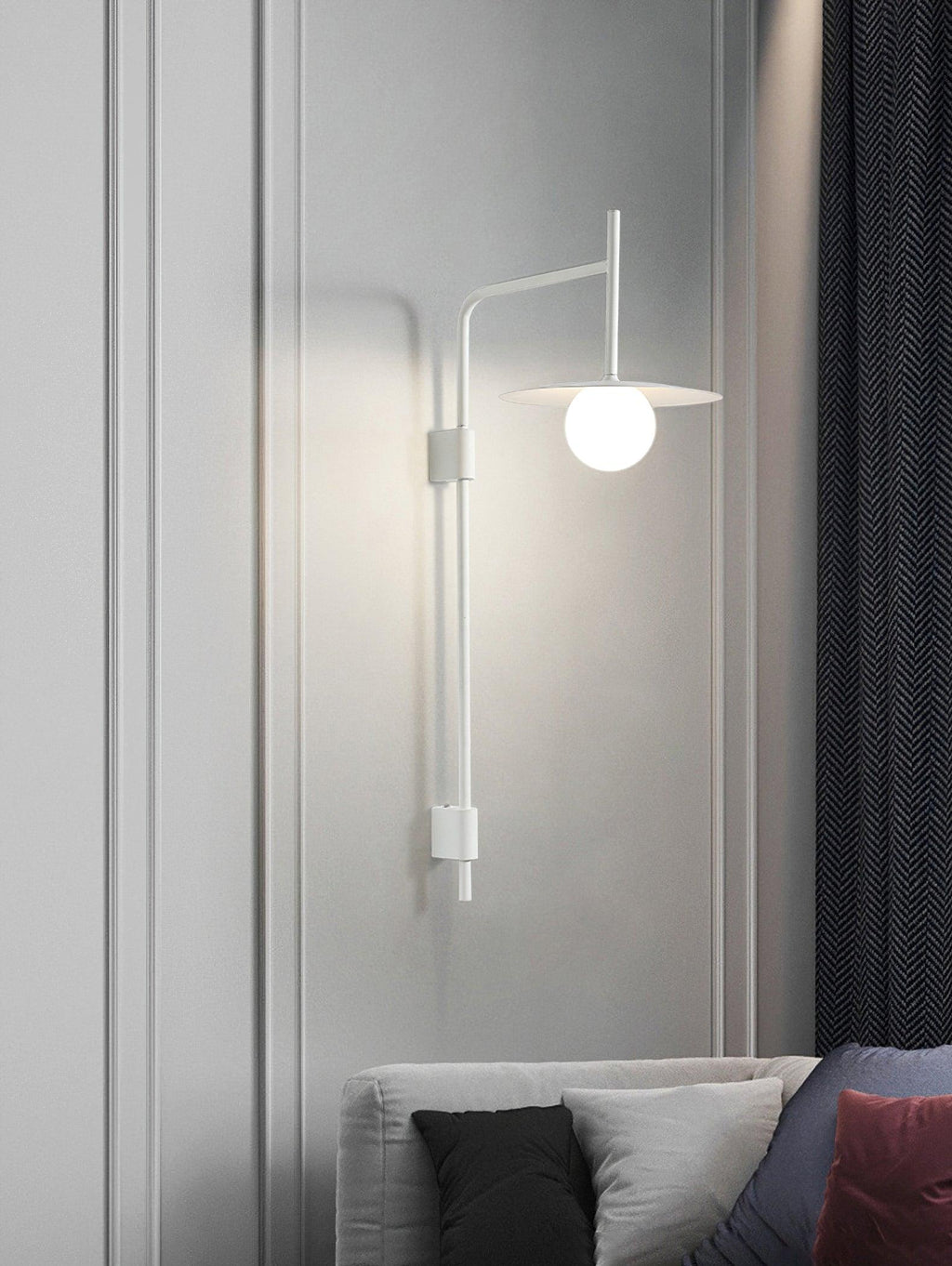 Gray swing arm wall lamp with frosted glass shade lit