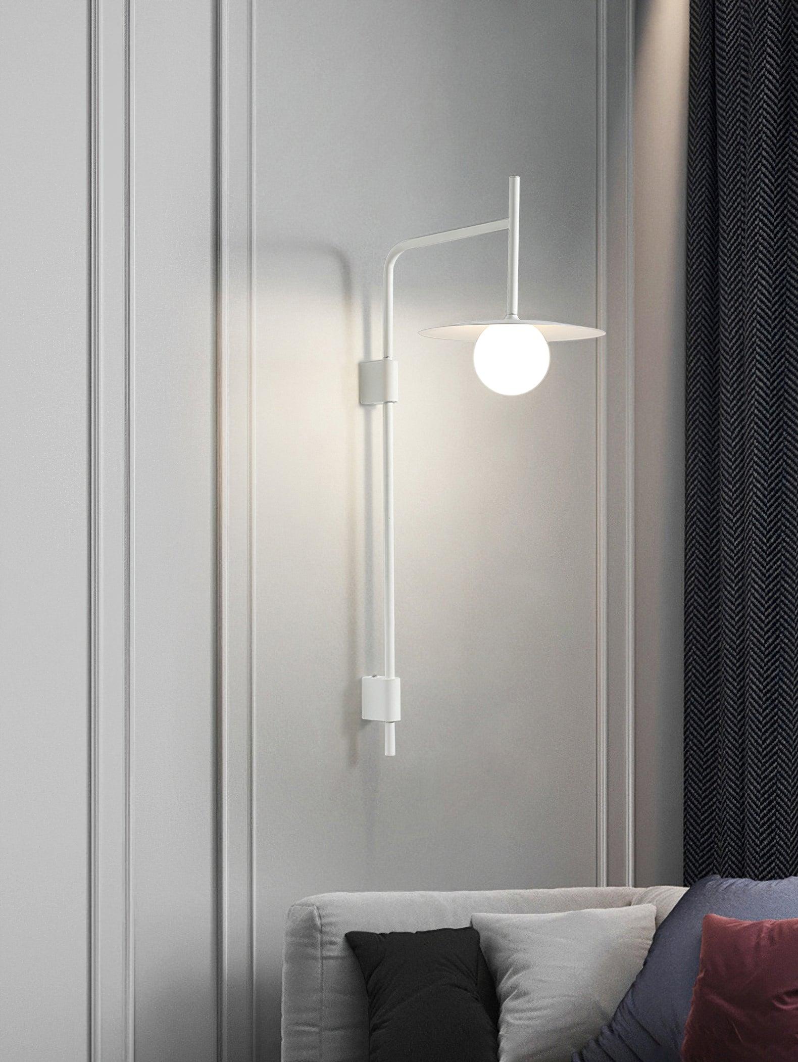 Gray swing arm wall lamp with frosted glass shade lit