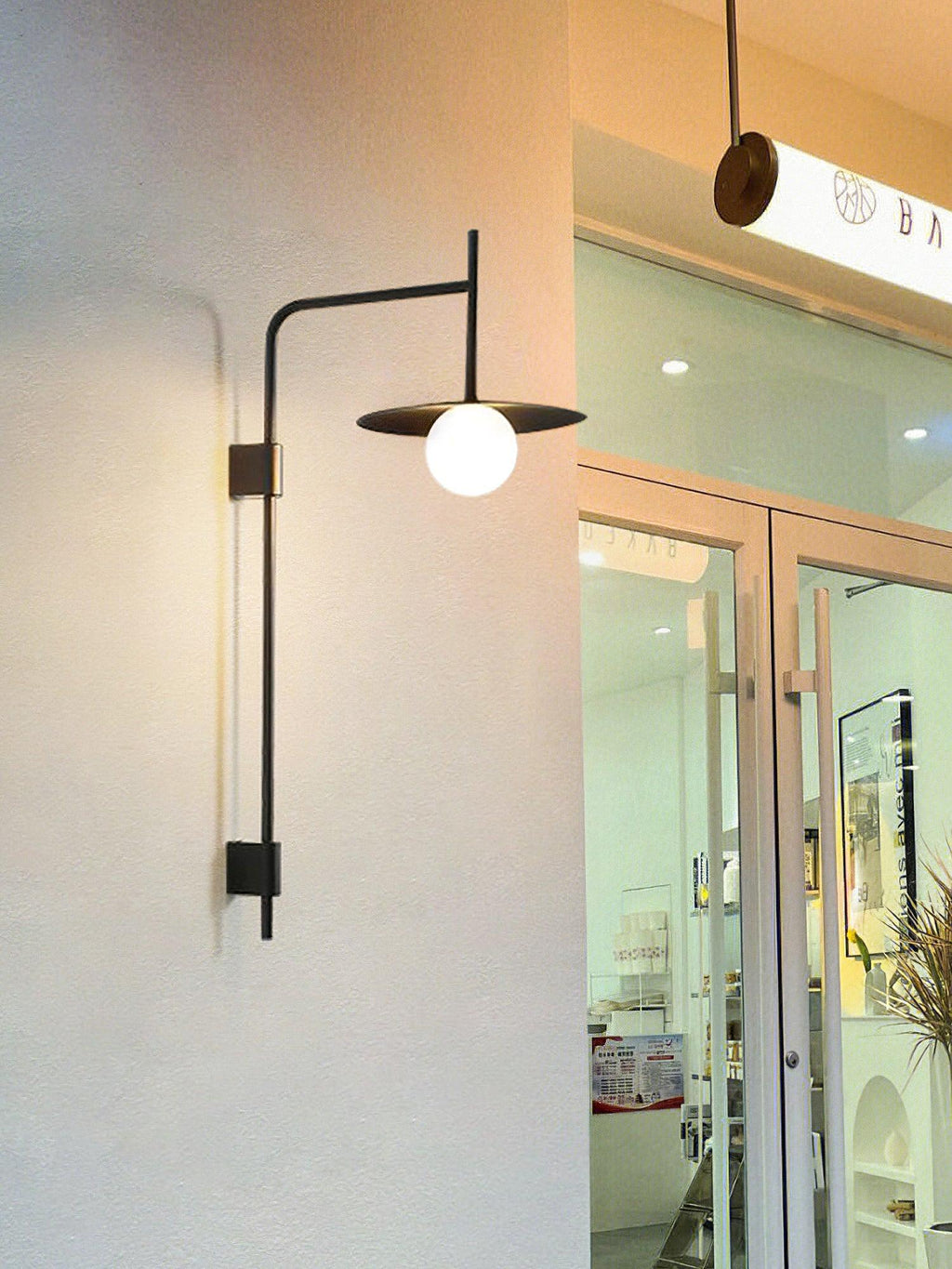 Swing arm wall lamp casting warm light in a bedroom