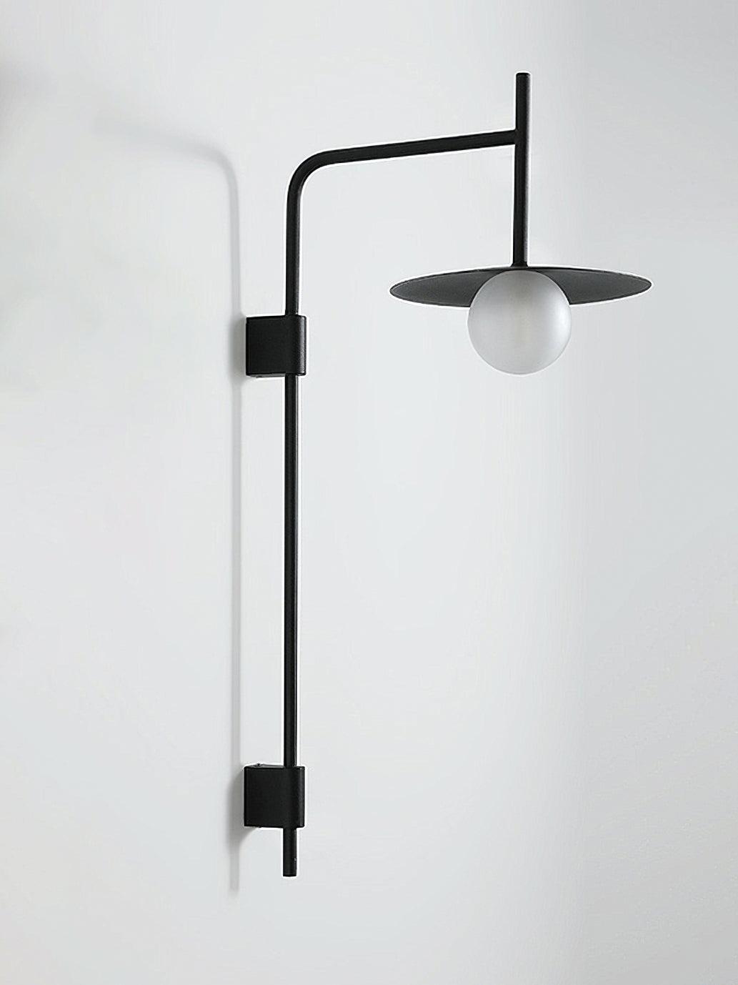 Swing arm wall lamp with frosted glass shade in a quiet nook