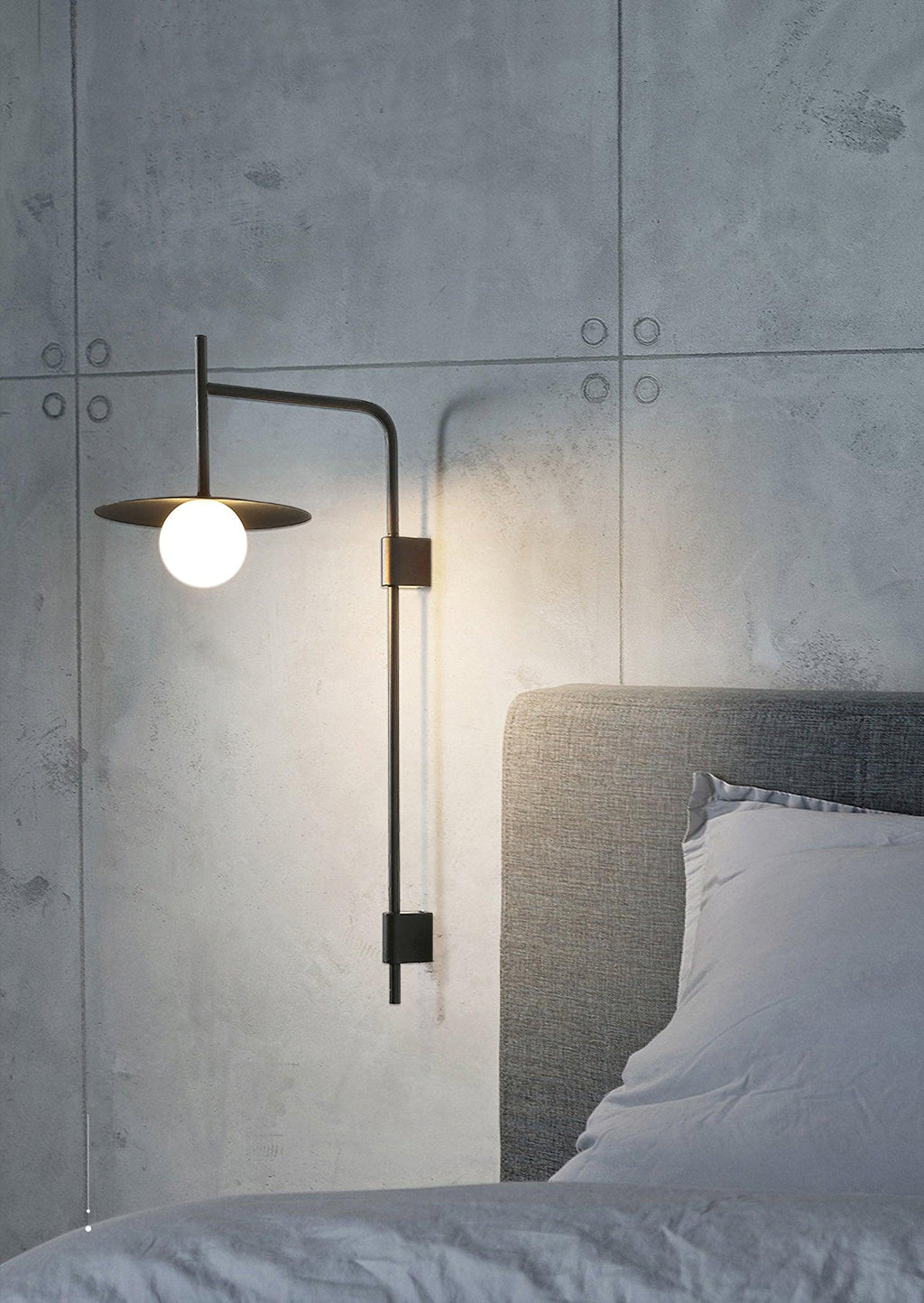 Swing arm wall lamp with frosted glass shade beside seating