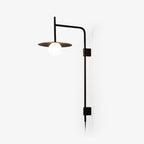 Swing arm wall lamp with intricate iron frame and glass shade