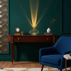 Oval crystal glass table lamp casting warm light in a living space