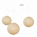 Round white paper pendant glowing in a styled space
