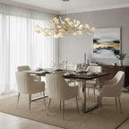 Porcelain ginkgo chandelier on brass branches in warm light