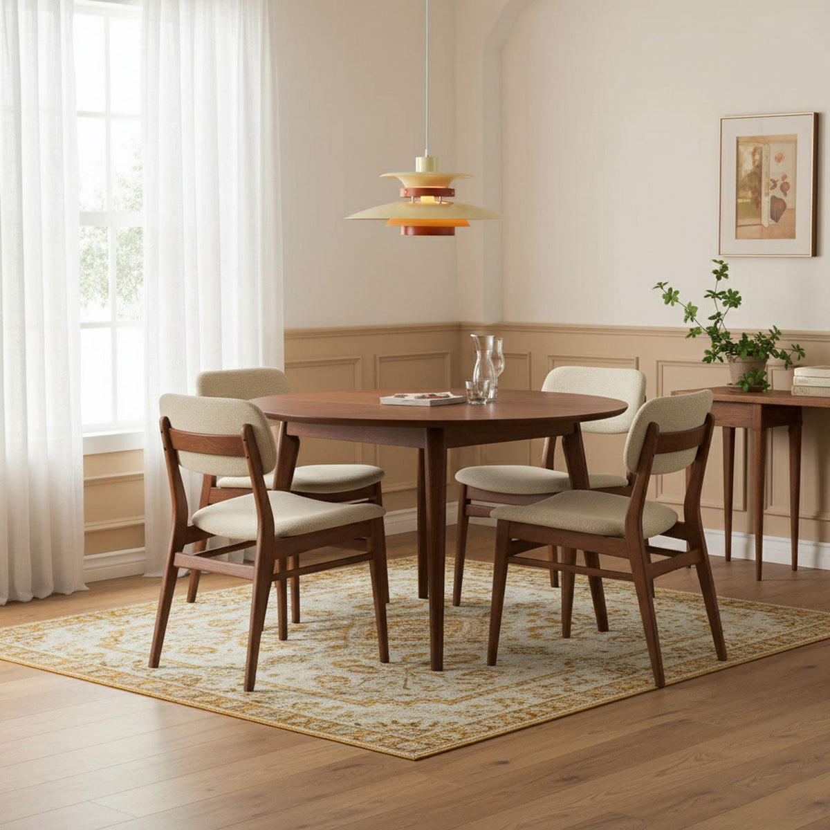 A beige Clérachic pendant hangs over a round wooden dining table by a window.
