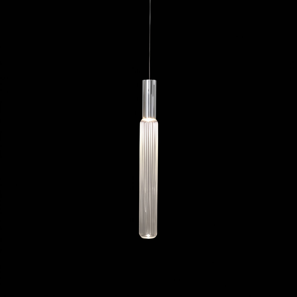 A slim chrome rod suspends this Clérachic pendant's fluted glass cylinder, lit against black.