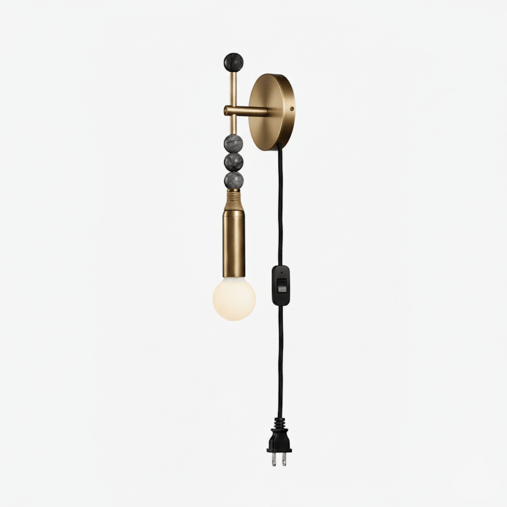 Clérachic plug-in wall lamp on white, dark stone beads above a lit glass globe and a black cord ending in a plug.