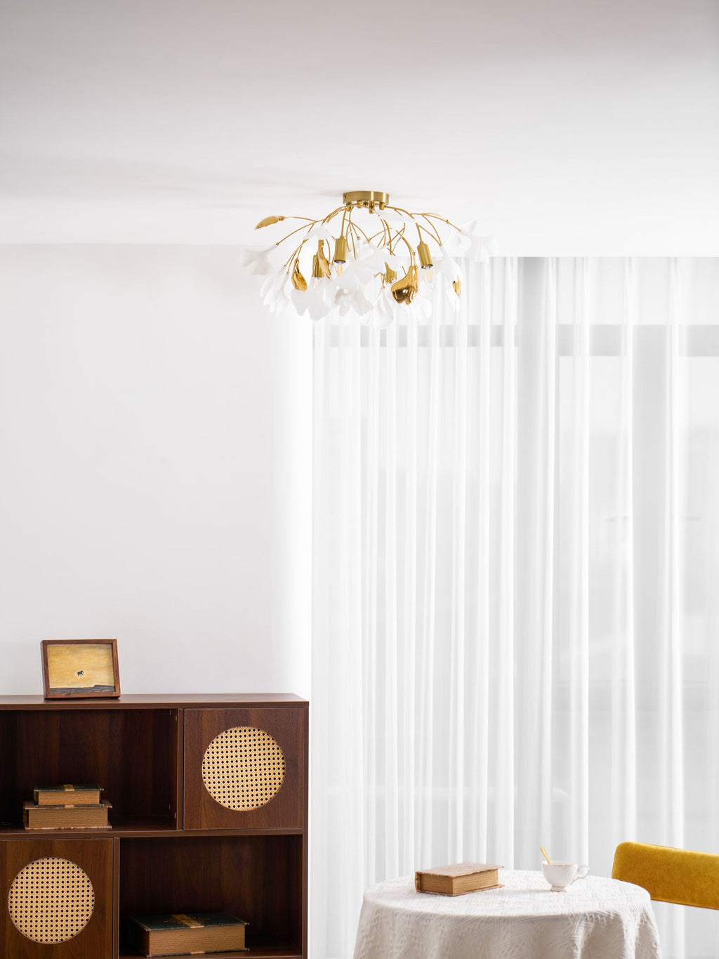 Ceramic ginkgo leaf ceiling lamp lit above a living room