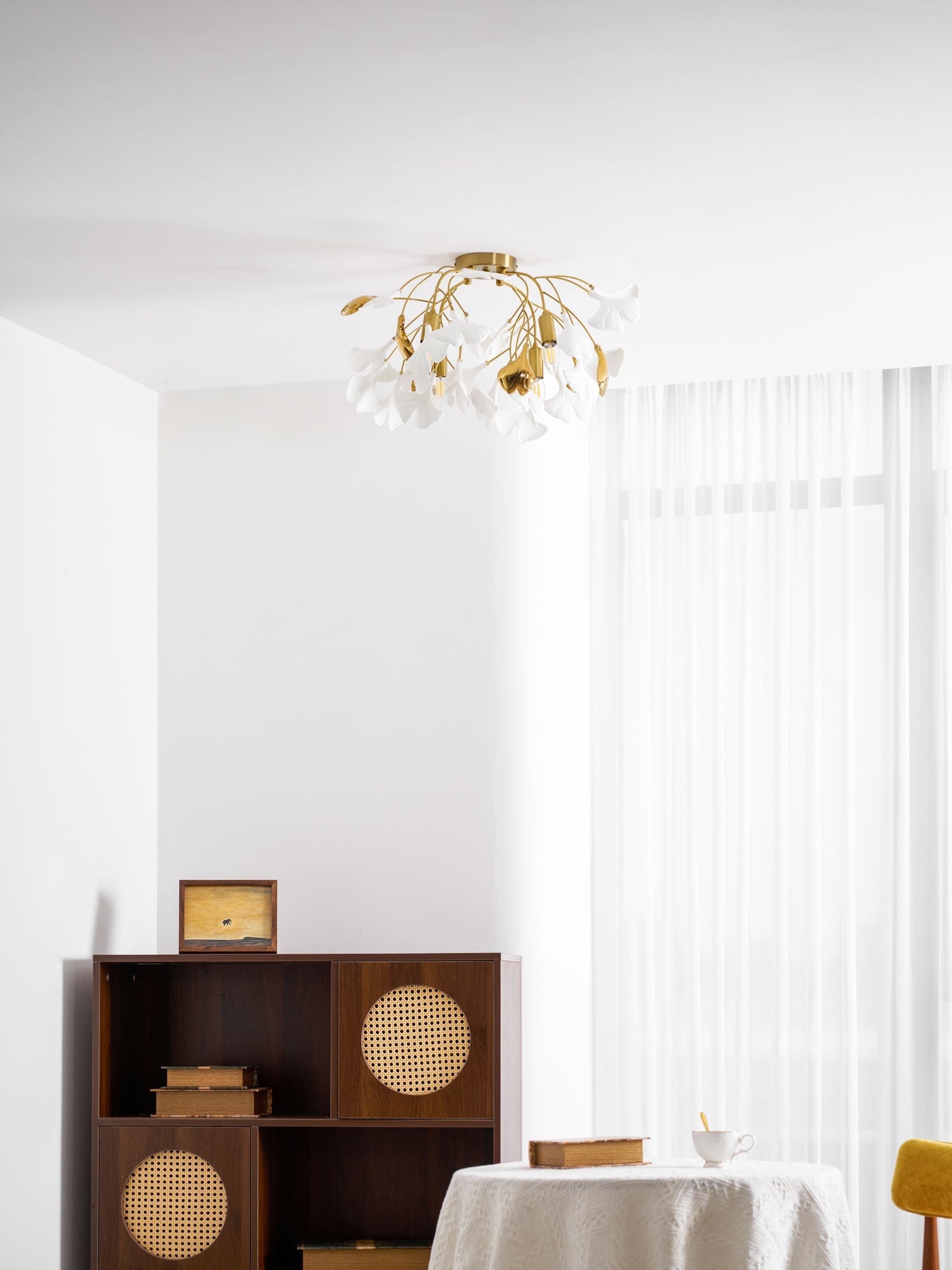 Ginkgo leaf ceiling fixture casting warm light overhead
