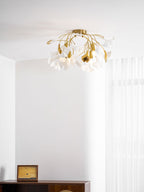 Ceramic ginkgo leaf ceiling light shown lit at night