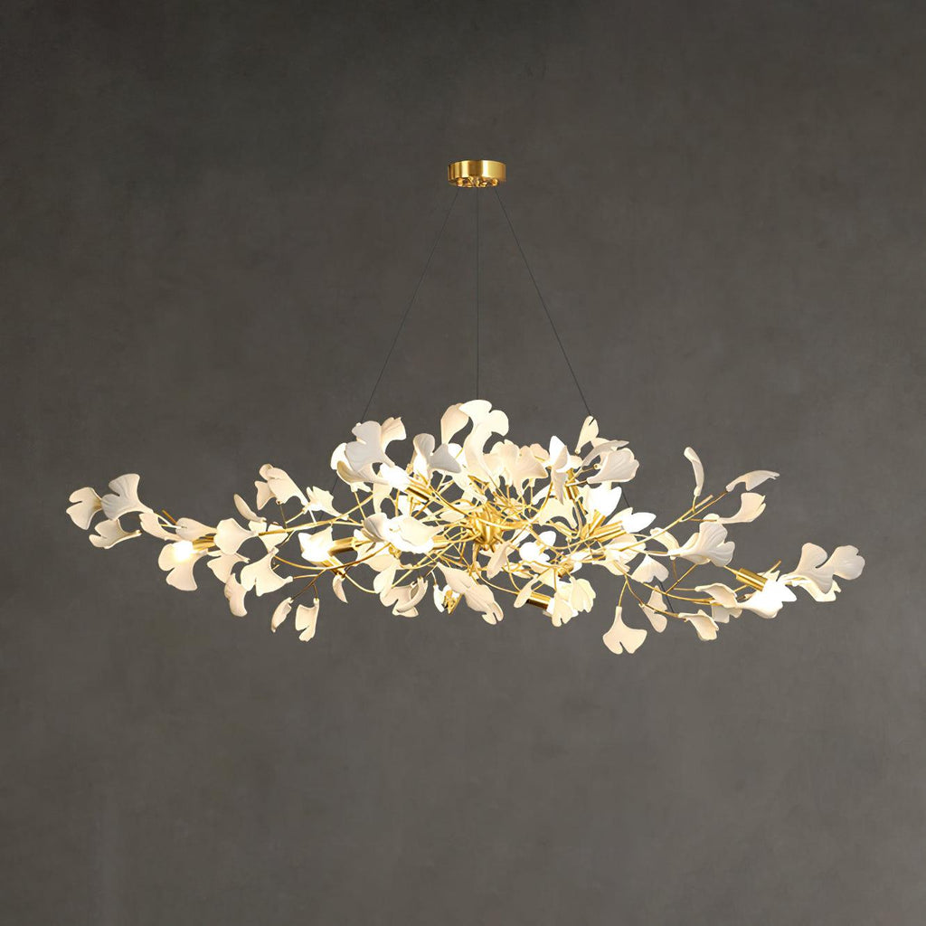 Linear ginkgo chandelier detail of porcelain leaves on a brass bough