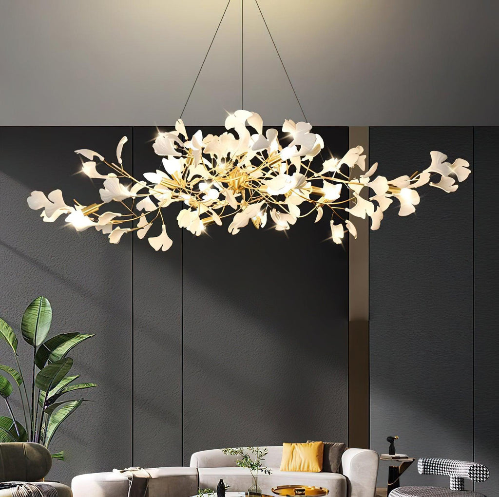 White porcelain ginkgo leaves spread along a brass bough