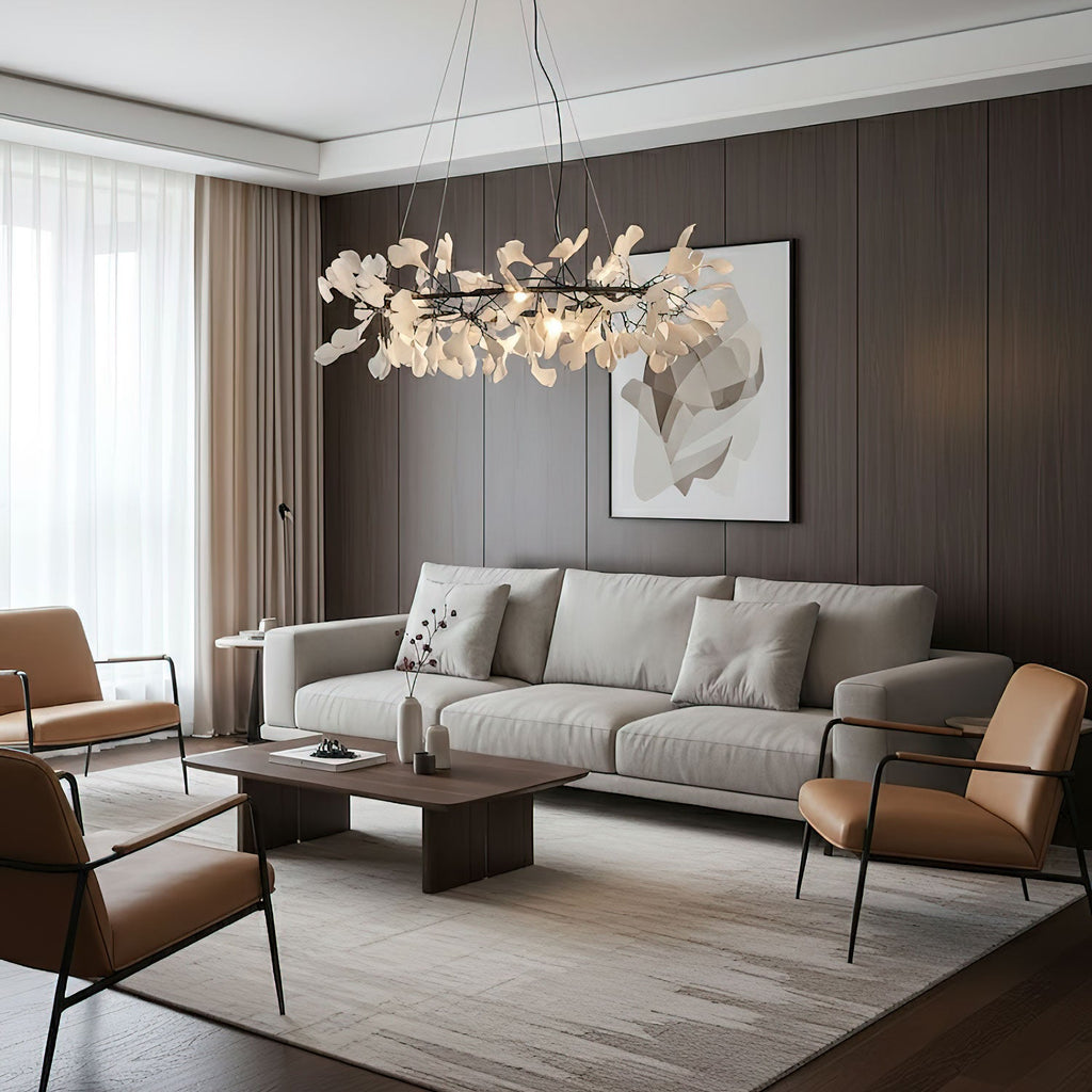 Round ginkgo leaf chandelier glowing over a wooden table