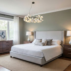 Brass chandelier with porcelain ginkgo leaves above a table