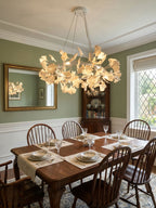 Brass crown chandelier ringed with porcelain ginkgo leaves