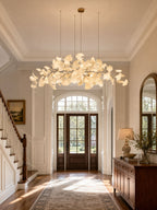 Linear chandelier of porcelain leaves over a kitchen island