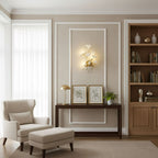 Ginkgo leaf wall lamp glowing warm beside a doorway