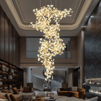 The chandelier dropping through a double-height living room with a coffered ceiling and mezzanine.