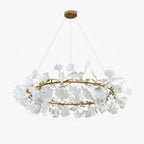 Round ginkgo leaf chandelier with warm light over a table