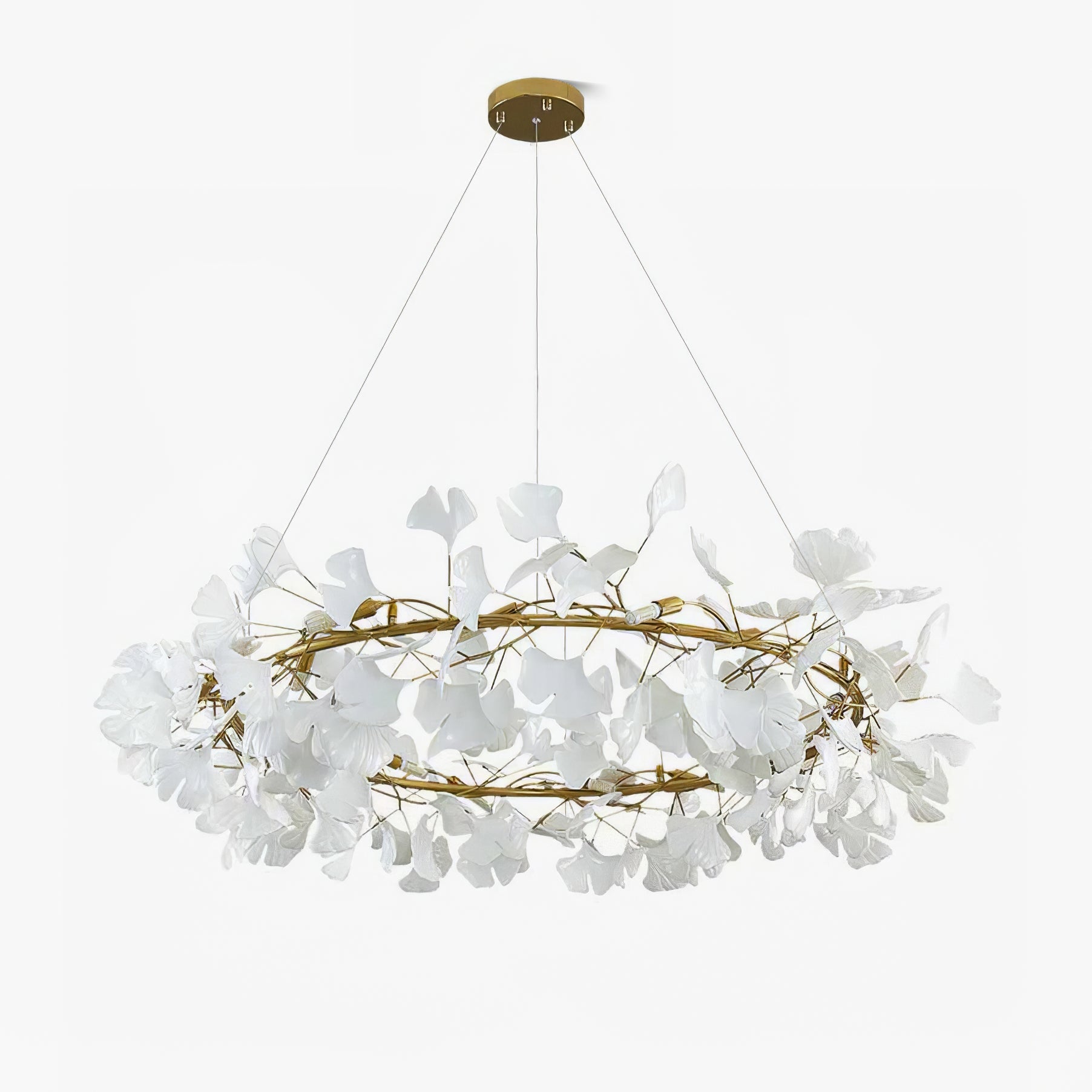 Round ginkgo leaf chandelier with warm light over a table