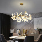 Porcelain ginkgo chandelier with brass ring on neutral backdrop