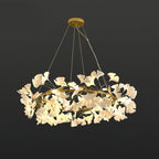 Round brass chandelier crowned with white porcelain ginkgo leaves