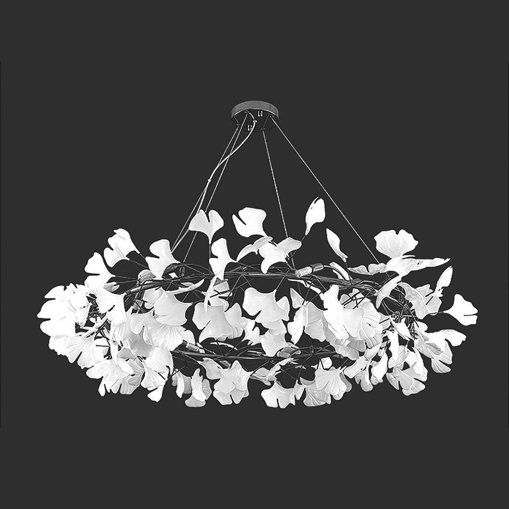 White porcelain ginkgo leaves arrayed on a glowing brass ring