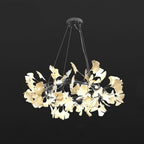 Porcelain ginkgo leaf chandelier glowing above a dining table
