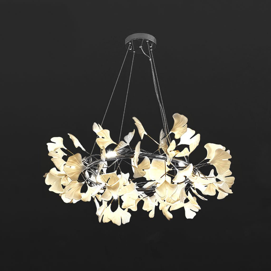 Porcelain ginkgo leaf chandelier glowing above a dining table