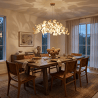 Dense white leaf chandelier glowing against a dark ceiling