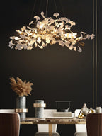 Leaf chandelier casting warm light over a dining area