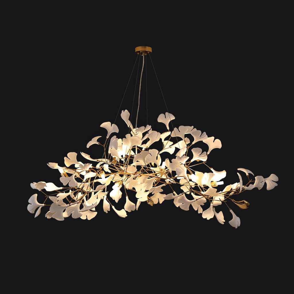 Long leaf chandelier above a dining table in a styled room