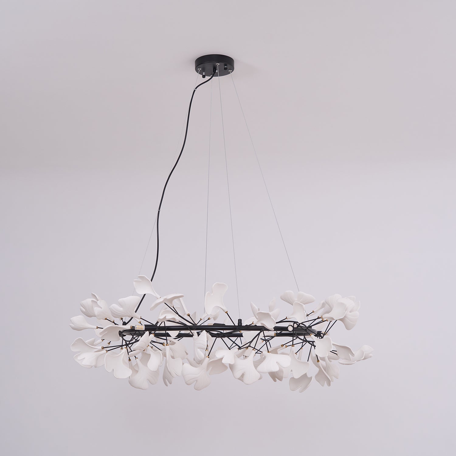 Round ginkgo chandelier with porcelain leaves and brass ring