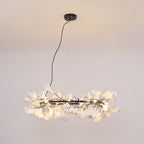 Wide porcelain ginkgo chandelier suspended over a long table