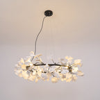 Porcelain ginkgo leaf chandelier glowing above a styled room