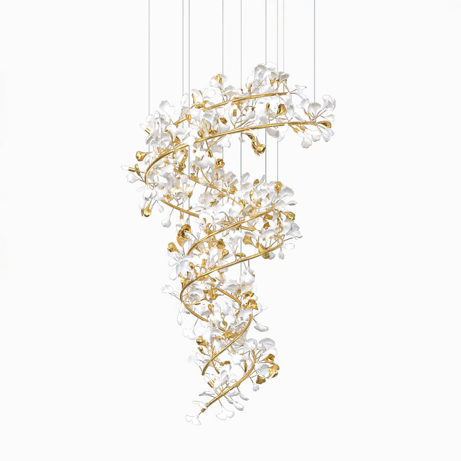 The gingko chandelier photographed on white, its gold branch column and white ceramic leaves lit from within.