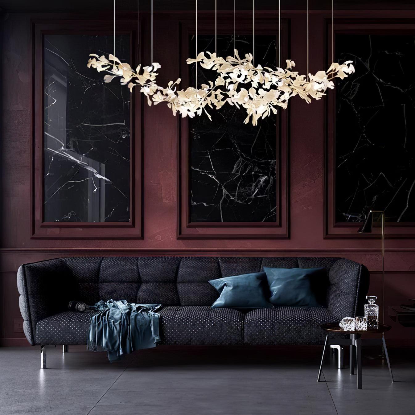 Lit against oxblood panelling and black marble panels, above a dark grey sofa.