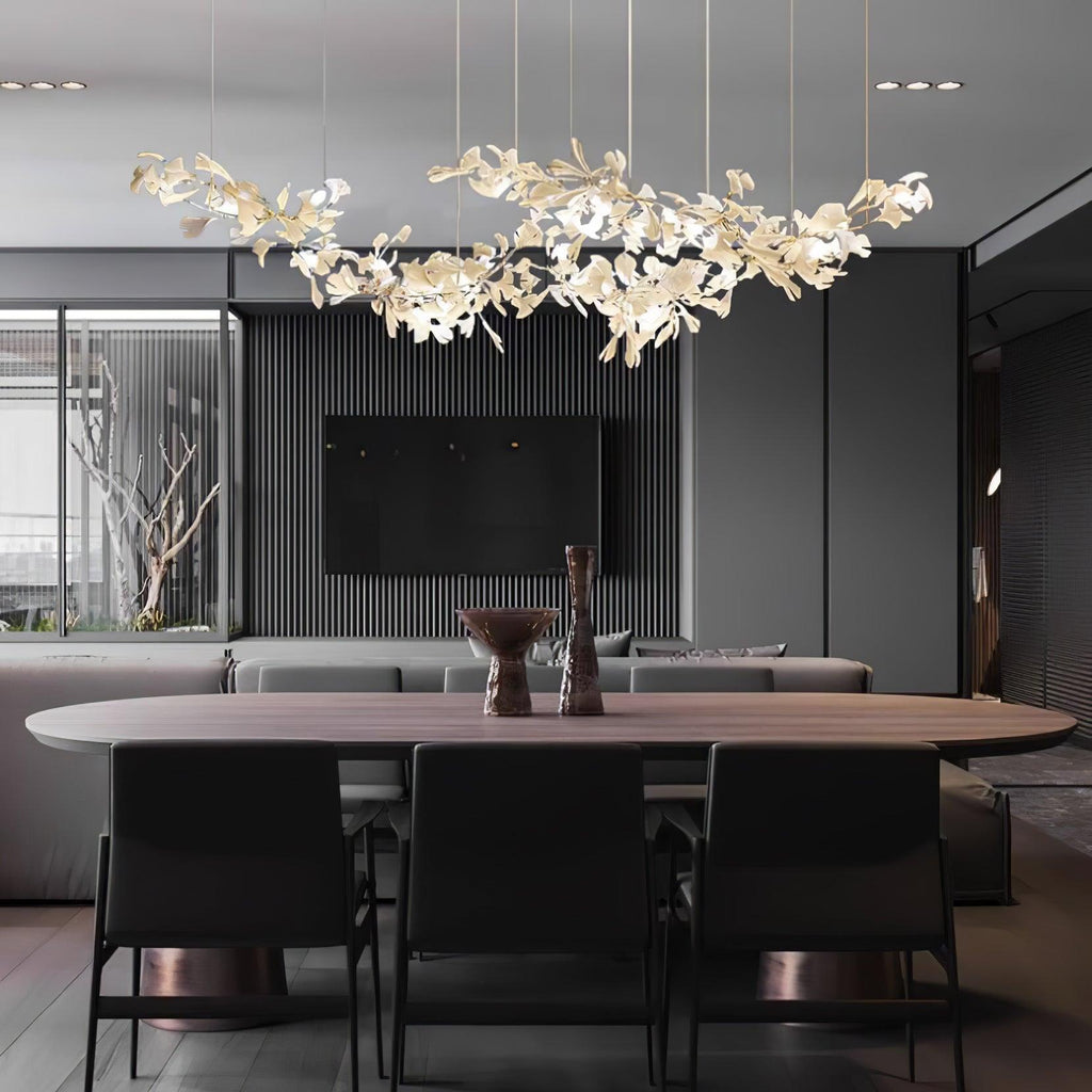 The chandelier lit over an oval walnut dining table in a dark, slatted-wall dining room.