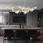 The chandelier lit over an oval walnut dining table in a dark, slatted-wall dining room.