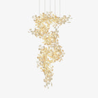 The gingko chandelier on white, gold branches spiralling down in a column hung with porcelain leaves.