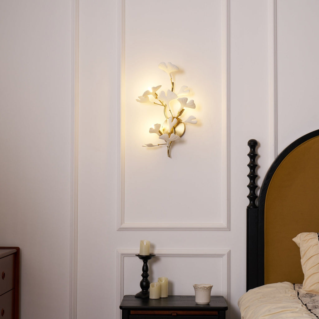 Ginkgo leaf wall lamp glowing warm above a console