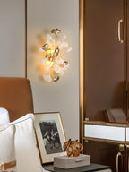 Ginkgo leaf wall lamp with layered porcelain leaves lit warm