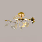 Ceramic ginkgo leaf ceiling light glowing warm against a pale wall